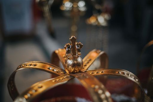 a closeup of a gold crown with a cross