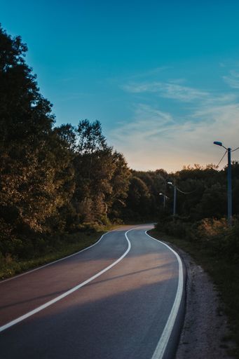 A winding highway and the clear sunset sky in the background