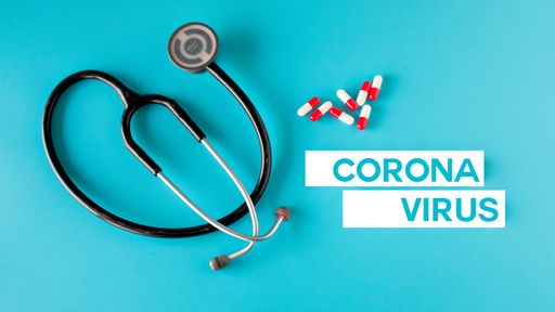 An overhead shot of medicaments and a stethoscope with Coronavirus text on the light blue background