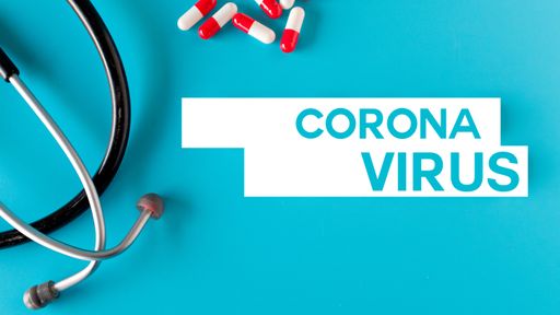 An overhead shot of medicaments and a stethoscope with Coronavirus text on the light blue background