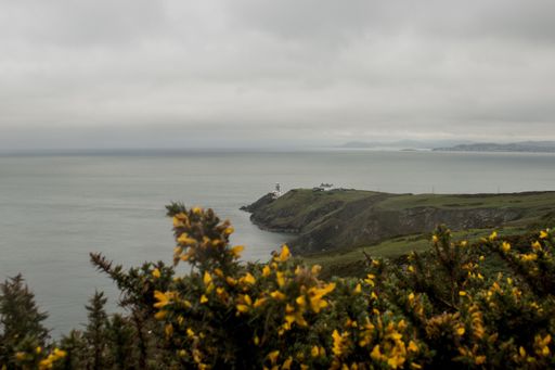 A vertical shot of the Baily Lighthouse in  Dublin Ireland on a gloomy day
