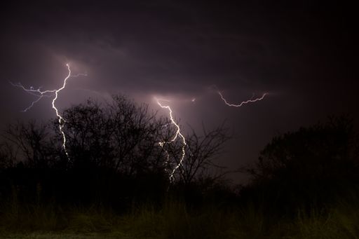 A view of flashes of lightning marked on the stormy clouds sky