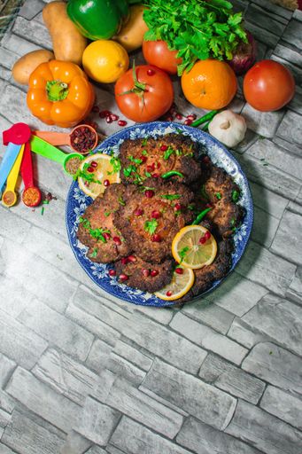 A view of the delicious food in the plate and vegetables on the table