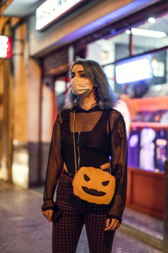A cool attractive blue-haired young lady wearing a sanitary mask - concept of the new normal