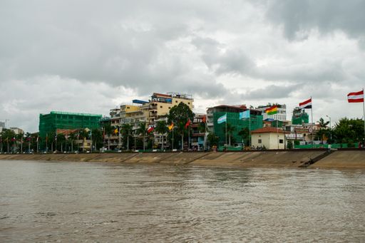 The dark gloomy clouds and heavy monsoon rain falling on the confluence of the Tonle Sap and Mekong