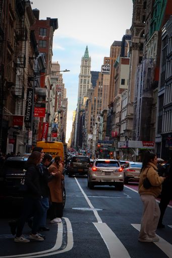 A vertical eye-level shot of a street full of cars and people, Soho, Manhattan, New York
