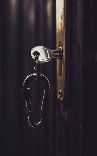 A vertical shot of keys stuck in a lock