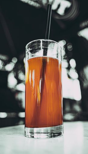 A low angle shot of a glass of fresh orange or sea buckthorn juice