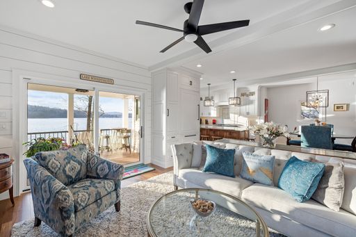 A beautiful light living room with white walls and glass doors to the balcony