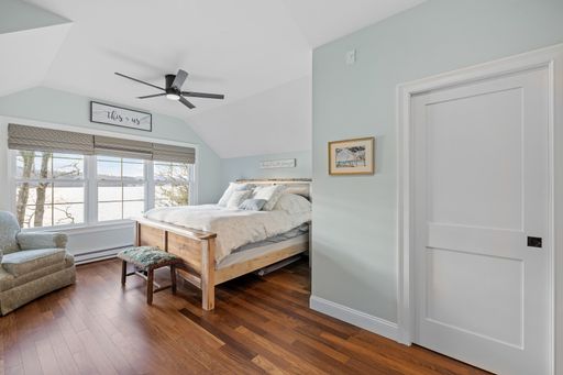 A beautiful light bedroom with a comfortable against the white walls