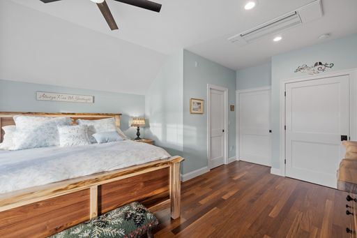 A beautiful light bedroom with a comfortable against the white walls