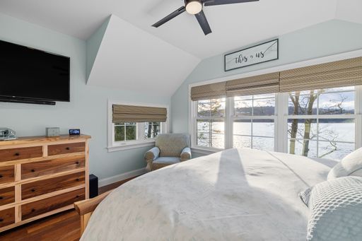 A beautiful light bedroom with a comfortable against the white walls