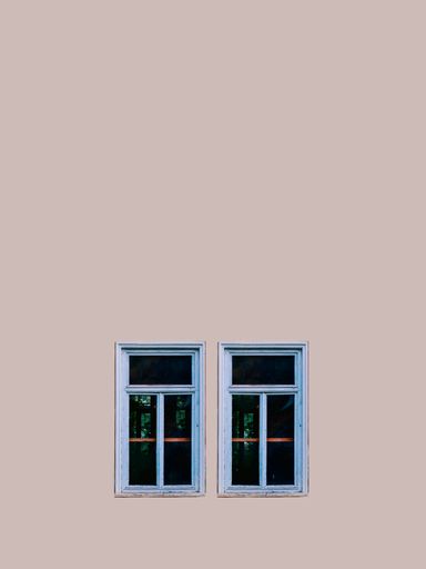 A vertical shot of two windows on a cream color background with copy space above