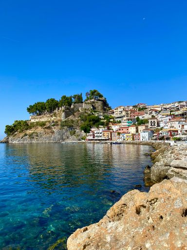 A vertical shot of the beautiful shore of Parga with houses in Greece