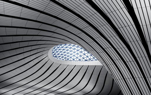 A modern architectural structure with geometric and curvilinear pattern