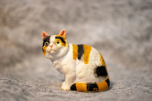 A closeup of a toy figurine of a cat