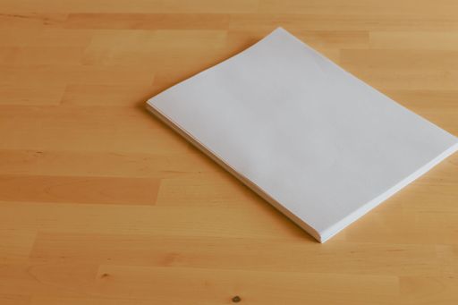 An office table with stack of paper sheets