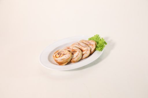 A high angle shot of chicken roulettes on a white plate