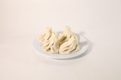 A high angle shot of tasty khinkali on a white background