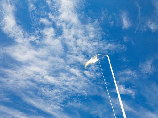 A low angle shot of a white flag
