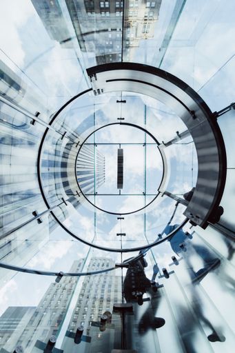 A low angle shot of a circular transparent stairway