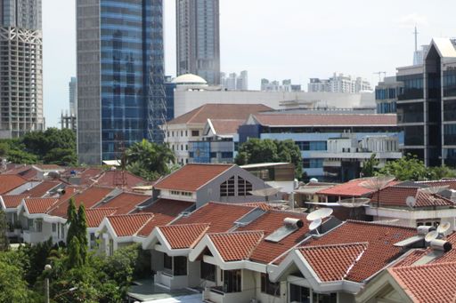 The housing background is seen from above with bright blue clouds