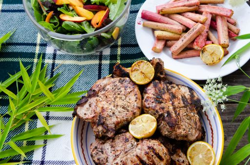 A high angle shot of delicious barbecued meat with a side of vegetables