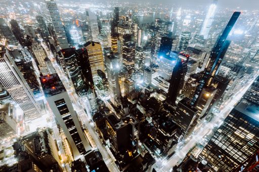 An aerial shot of the skyscrapers and buildings of New York City, United States captured at night