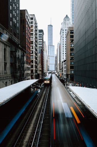 A vertical shot of the train going through the buildings of New York City, United States