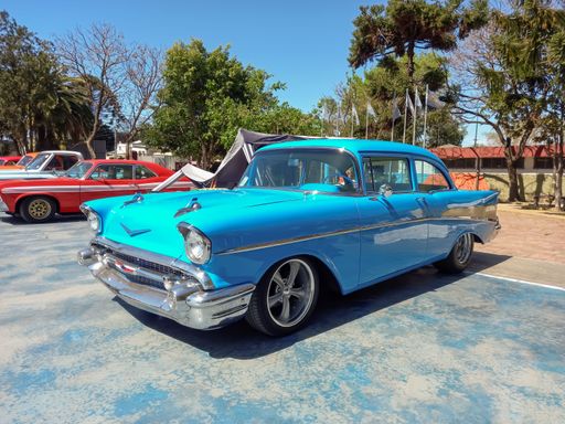 Lanus, Argentina - Sept 25, 2022: Old sky blue 1957 Chevrolet Chevy Bel Air sport sedan two door in the a park. Iconic classic car.