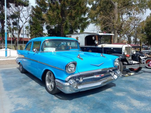 Lanus, Argentina - Sept 25, 2022: Old sky blue 1957 Chevrolet Chevy Bel Air sport sedan two door in the a park. Iconic classic car.
