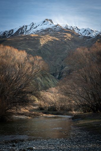 A vertical shot of stream and mountain in Mt Aspiring National Park in New Zealand