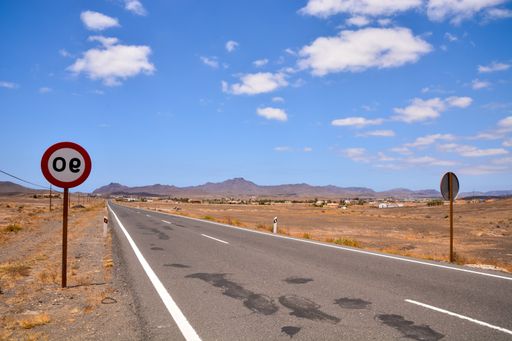 A closeup shot of street signs on the empty road