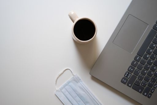 Topview of coffe, computer and mask