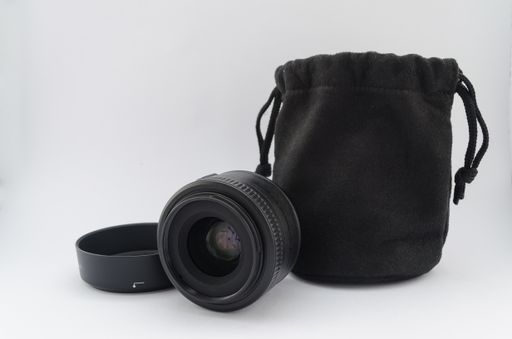 A closeup shot of lens for a camera and a pouch isolated on a white background