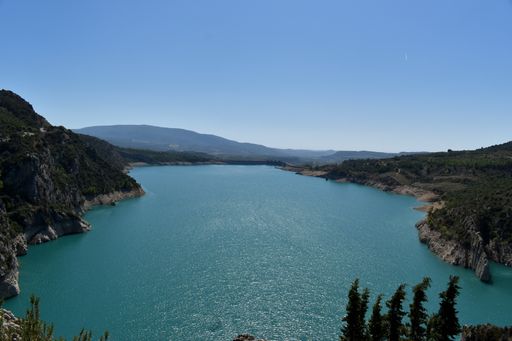 A high angle shot of cliffs and a blue river