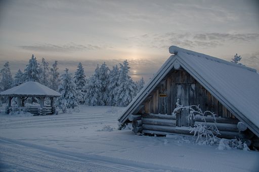 A beautiful cloudscape over white snow-covered cottages and fields in the countryside
