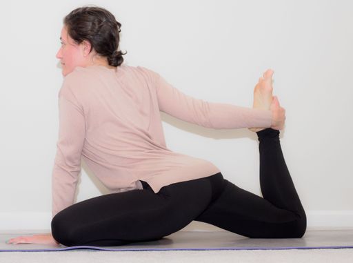 A young woman taking care of her mental and physical health by taking time to practice yoga