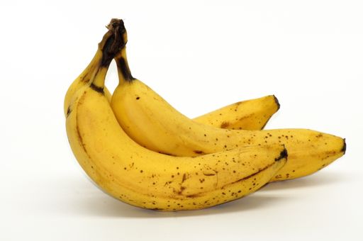 A closeup of a bunch of ripe bananas isolated on the white background