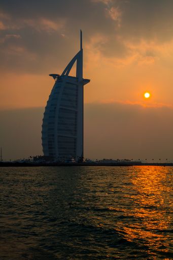 A vertical shot of the Burj Al Arab in Dubai at sunset