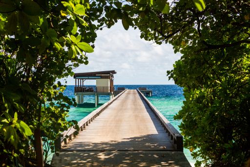A beautiful view from the grass arch of overwater villas in the Maldives