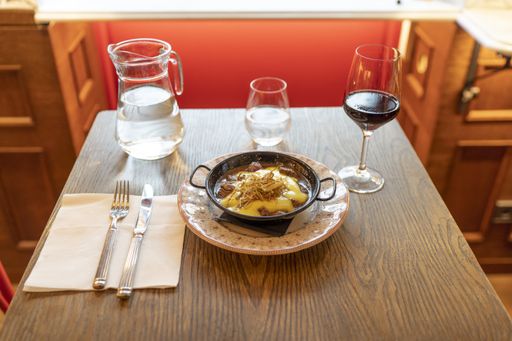 An appetizing beef dish with melted cheese on top in a restaurant