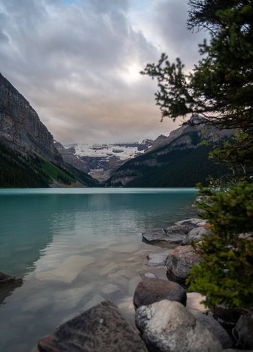 A vertical shot of the mountains and the Moraine Lake in Banff National Park in Alberta, Canada