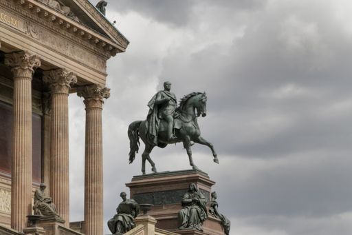 A low angle shot of the statue of Alte Nationalgalerie museum in Berlin, Germany, on a cloudy day