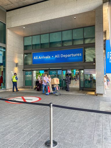 Passengers wearing face masks arriving at Cape Town Int Airport during coronavirus lockdown. People collecting family are not allowed inside.