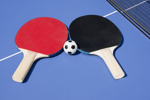 A closeup shot of rackets on ping pong table