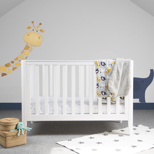 An interior of light baby room with a modern cozy crib and cute animal paintings on a wall