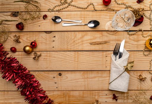 A top view of cutlery on a wooden Christmas background