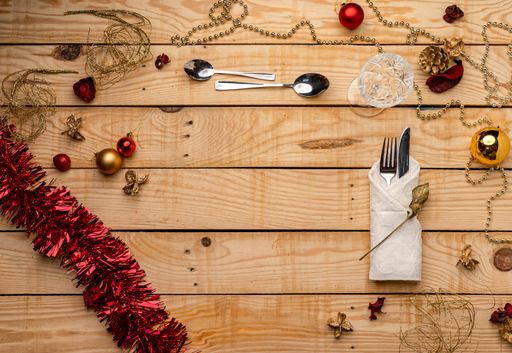 A top view of cutlery on a wooden Christmas background