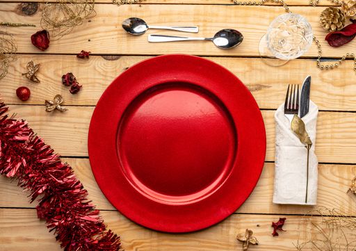 A top view of cutlery and plates on festive wooden background